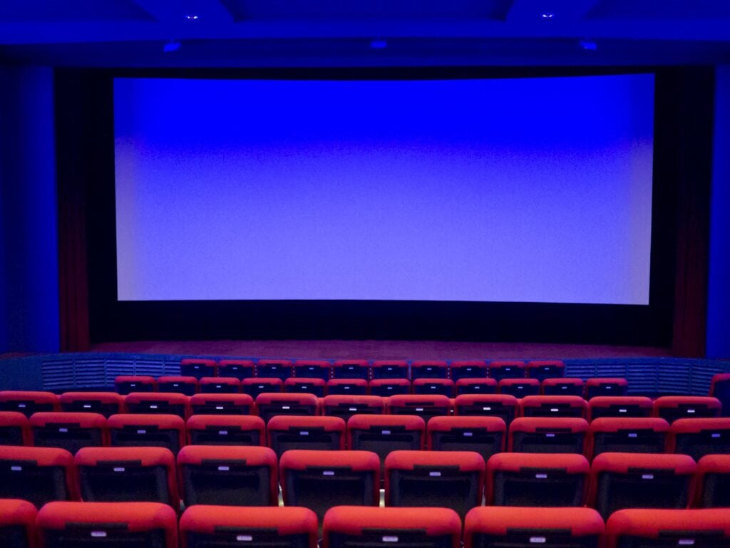 Empty cinema auditorium. Projection screen is ready for adding a picture